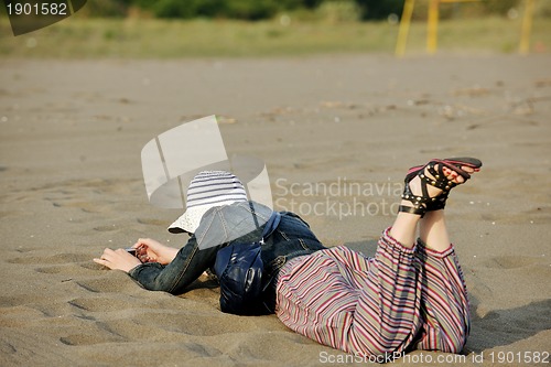 Image of young woman relax  on beach