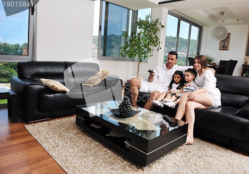 Image of family wathching flat tv at modern home indoor
