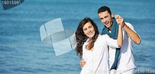 Image of happy young couple have fun at beautiful beach