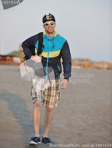 Image of man walk on beach