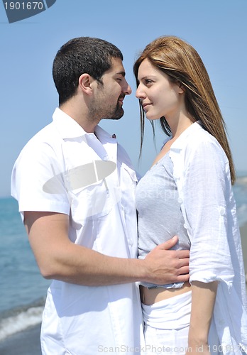 Image of happy young couple have fun on beach