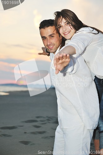 Image of happy young couple have fun on beach