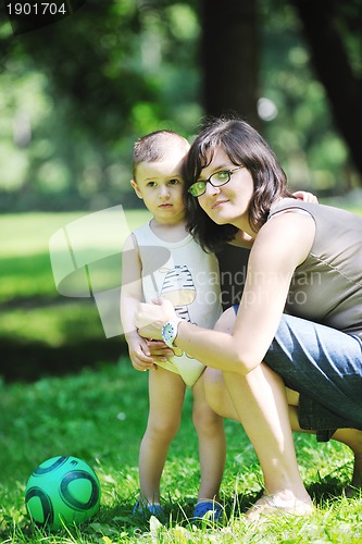 Image of happy children and mom have fun at park