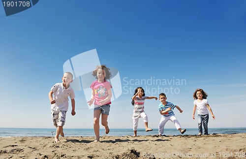 Image of happy child group playing  on beach