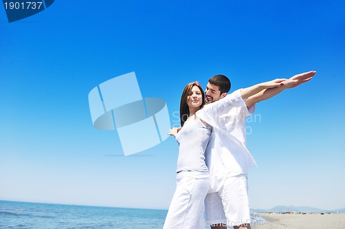 Image of happy young couple have fun on beach