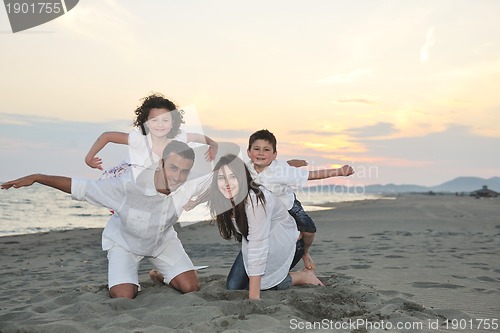Image of happy young family have fun on beach
