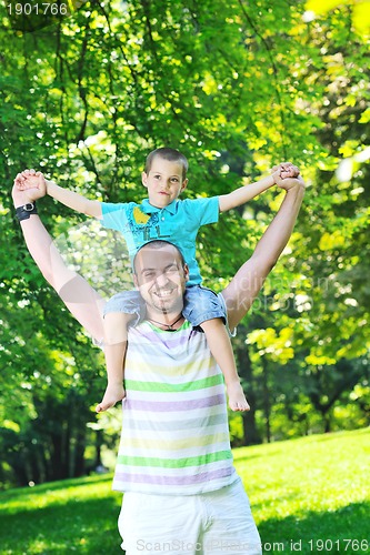 Image of happy father and son have fun at park