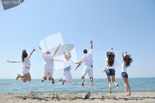 Image of happy people group have fun and running on beach