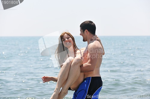 Image of happy young couple have fun on beach