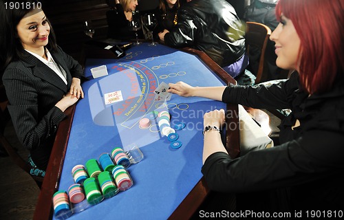 Image of woman play black jack card game in casino