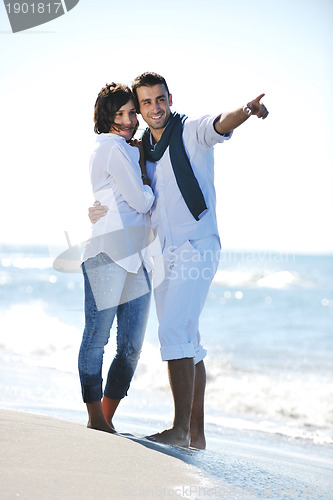 Image of happy young couple have fun at beautiful beach