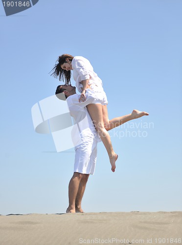 Image of happy young couple have fun on beach
