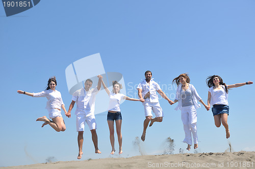 Image of happy people group have fun and running on beach
