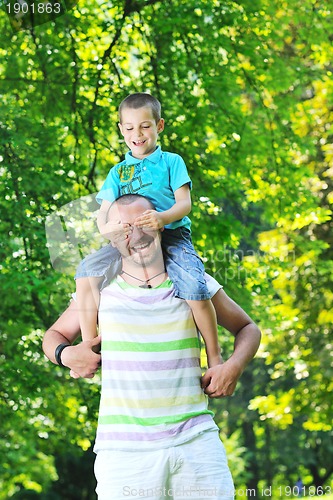 Image of happy father and son have fun at park