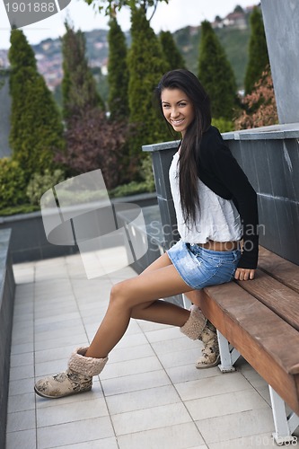 Image of beautiful young lady posing in garden