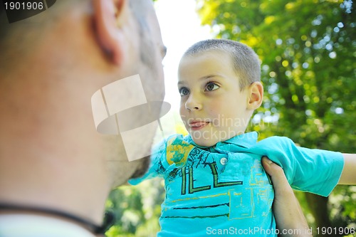 Image of happy father and son have fun at park