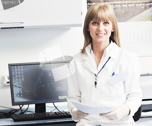 Image of female researcher holding up a test tube in lab