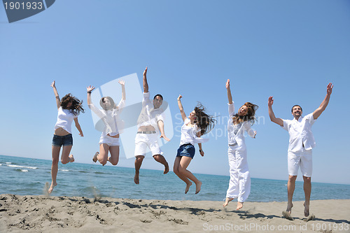Image of happy people group have fun and running on beach