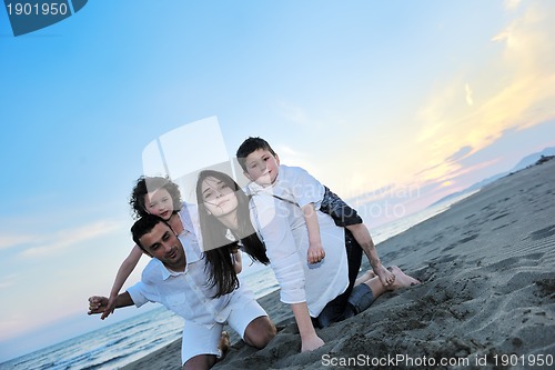 Image of happy young family have fun on beach
