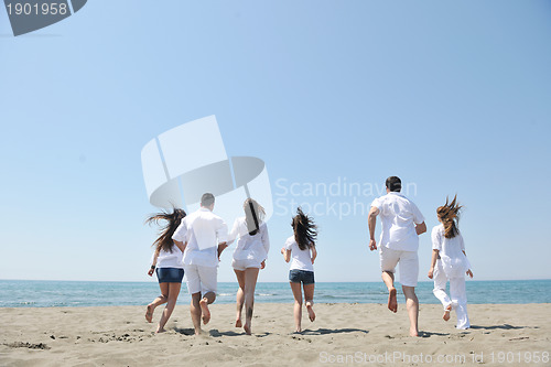 Image of happy people group have fun and running on beach