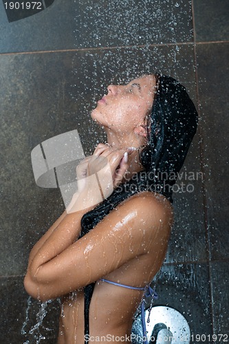 Image of sexy young woman enjoing bath under water shower