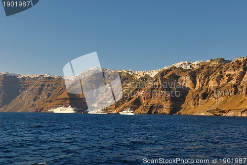 Image of santorini island coast with luxury yacht