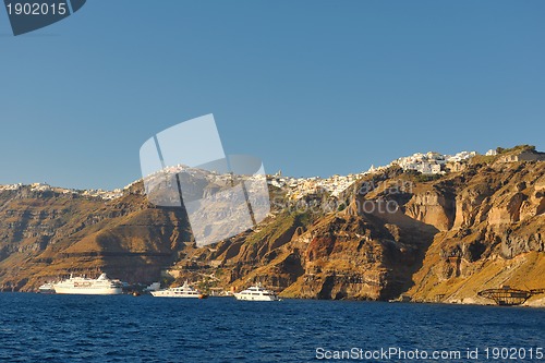 Image of santorini island coast with luxury yacht