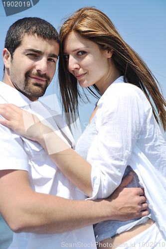 Image of happy young couple have fun on beach