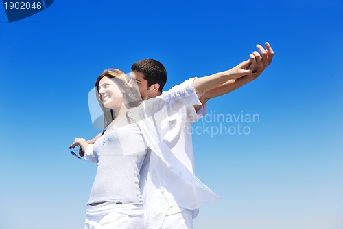 Image of happy young couple have fun on beach