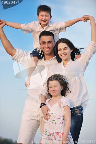 Image of happy young family have fun on beach