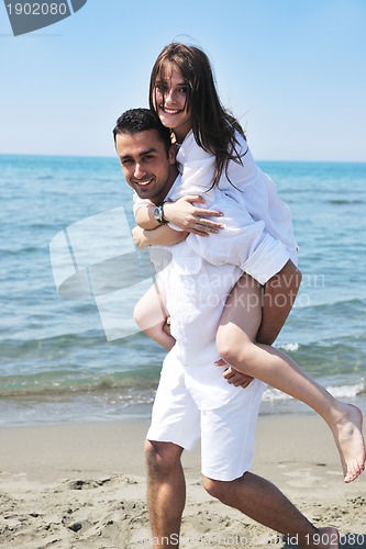 Image of happy young couple have fun on beach