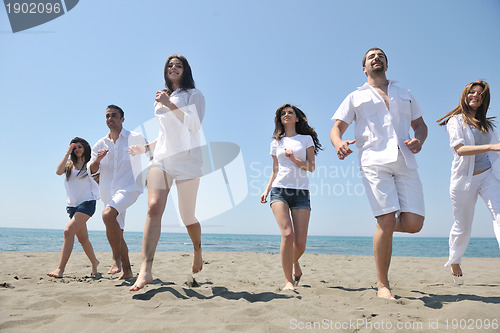 Image of happy people group have fun and running on beach