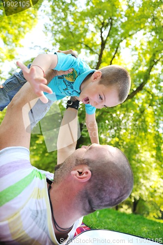 Image of happy father and son have fun at park