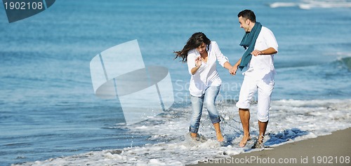 Image of happy young couple have fun at beautiful beach