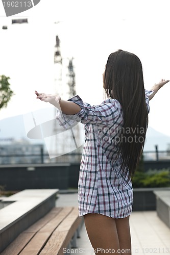 Image of beautiful young lady posing in garden