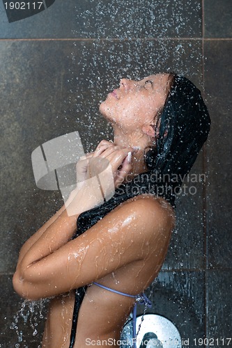 Image of sexy young woman enjoing bath under water shower