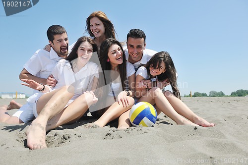 Image of Group of happy young people in have fun at beach