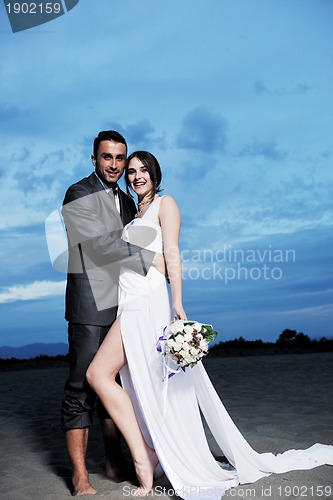Image of romantic beach wedding at sunset