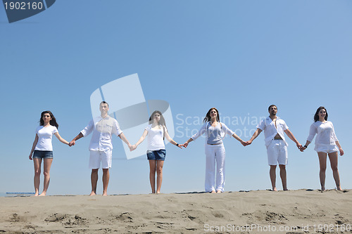 Image of happy people group have fun and running on beach