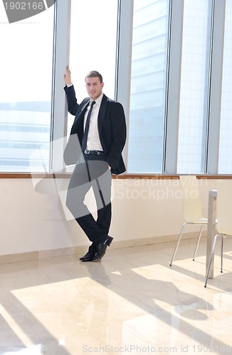 Image of young business man alone in conference room