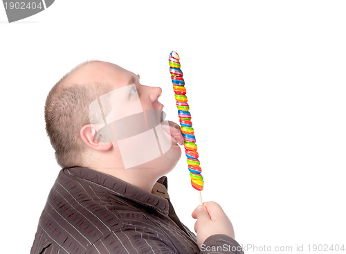 Image of Fat man enjoying a lollipop