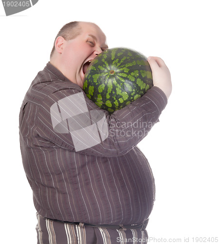Image of Obese man biting a watermelon