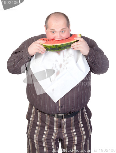 Image of Obese man eating watermelon