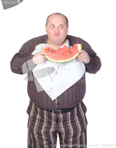 Image of Obese man eating watermelon