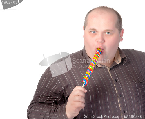 Image of Fat man enjoying a lollipop