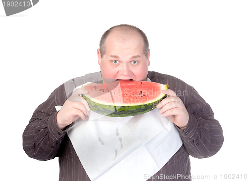 Image of Obese man eating watermelon