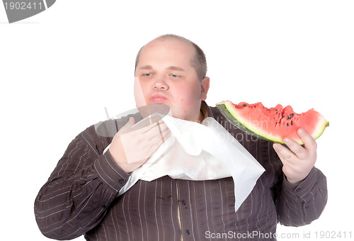 Image of Obese man eating watermelon