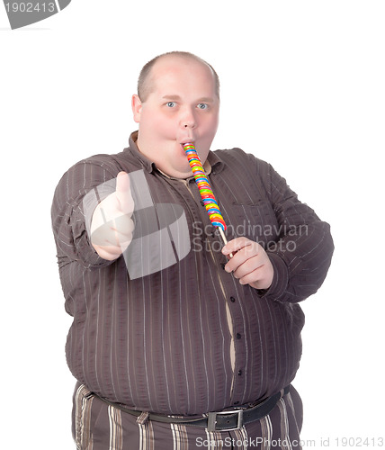 Image of Fat man enjoying a lollipop