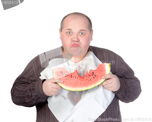 Image of Obese man eating watermelon