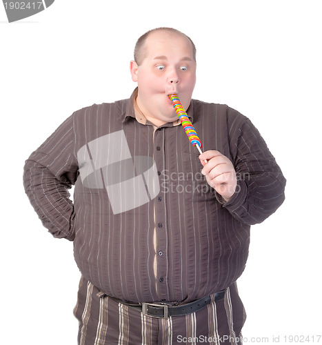 Image of Fat man enjoying a lollipop